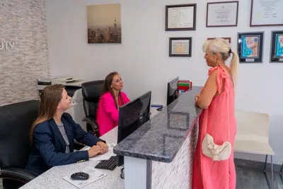patient scheduling her next dental appointment after getting her teeth whitened at Dental Beauty