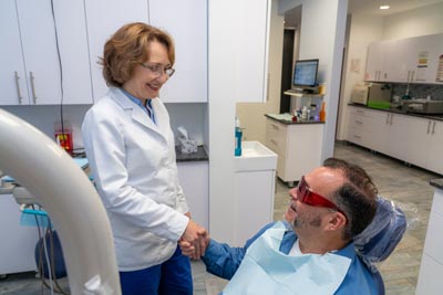Dr. Kurudimova talking with a patient after his routine dental cleaning at Dental Beauty in Feasterville, PA