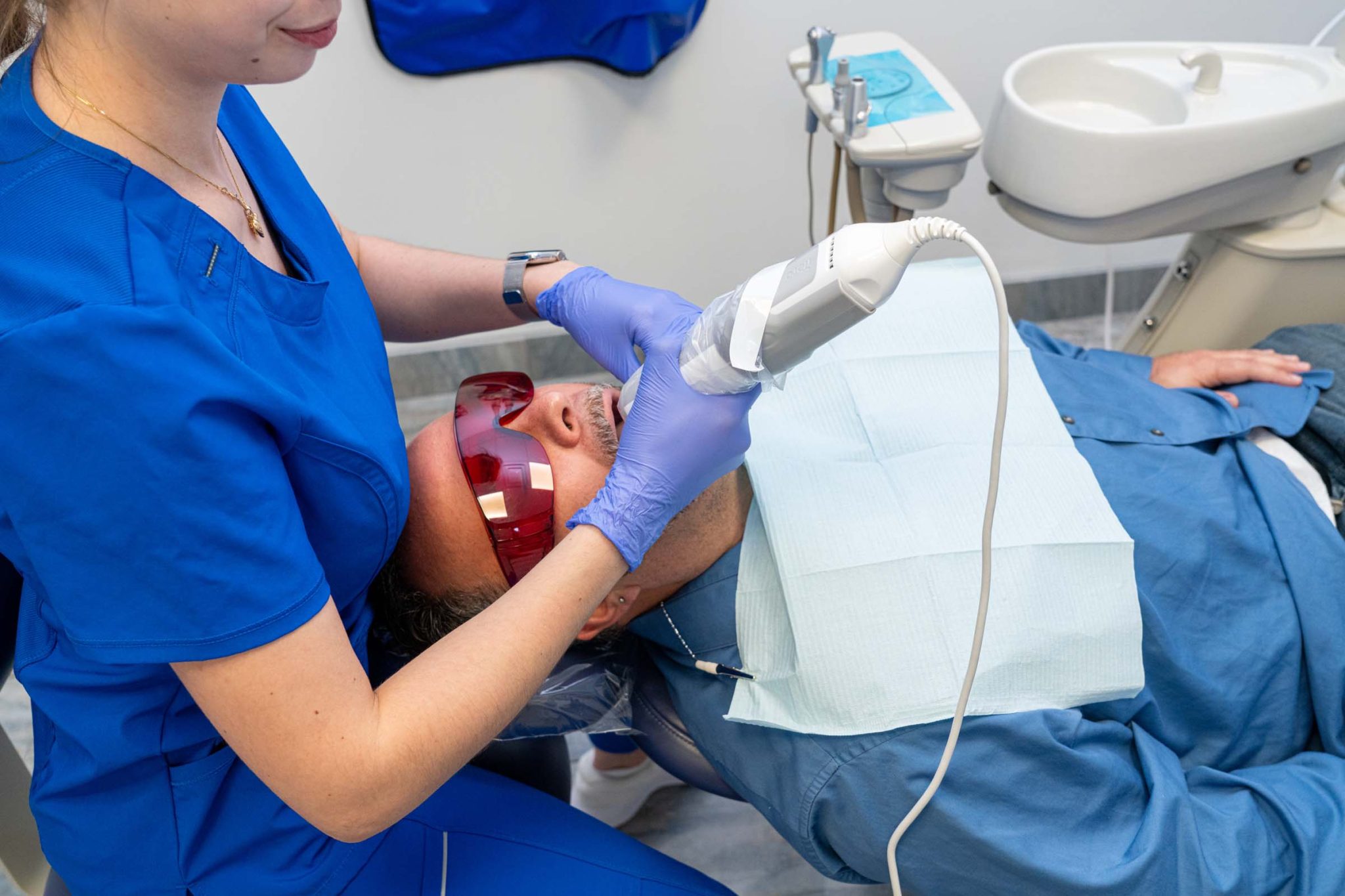 Dentist providing emergency dental care to a patient at Dental Beauty