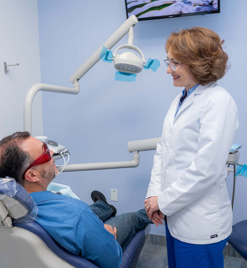 Dentist reviewing dental x-rays with a patient at Dental Beauty in Feasterville-Trevose, PA