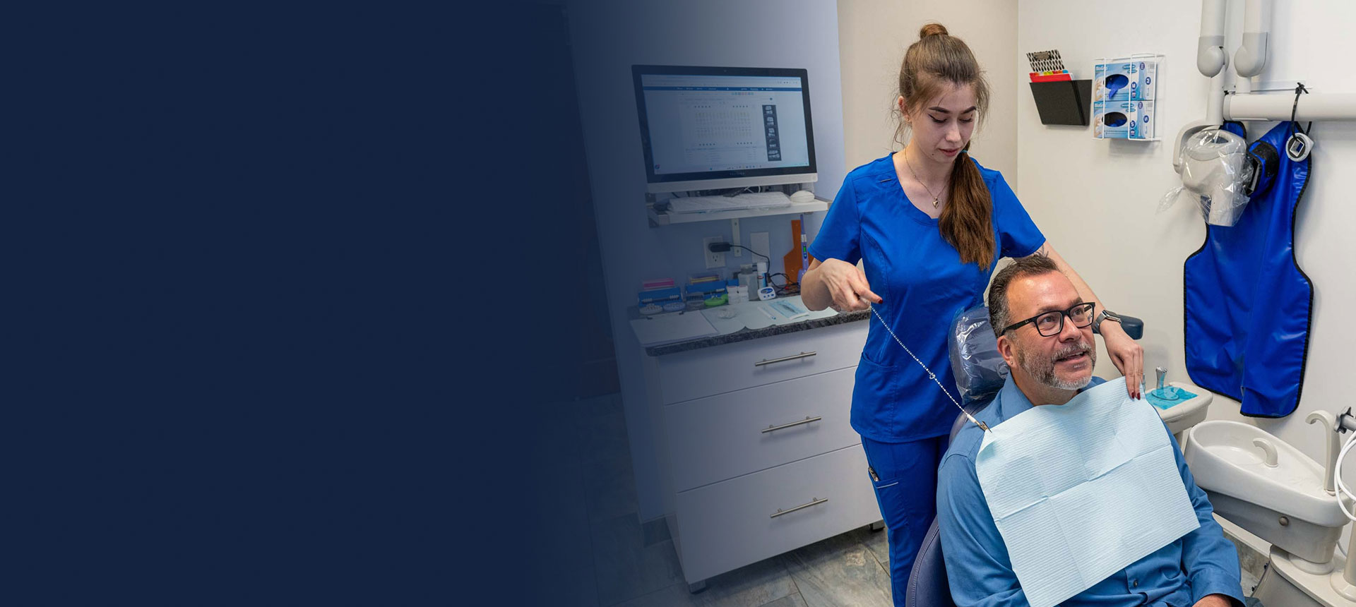 Dental hygienist preparing a patient for a preventive dental exam at Dental Beauty