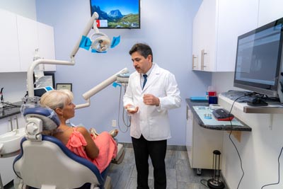 Dr. Kurudimov discussing restorative dentistry options with a patient at Dental Beauty in Feasterville, PA